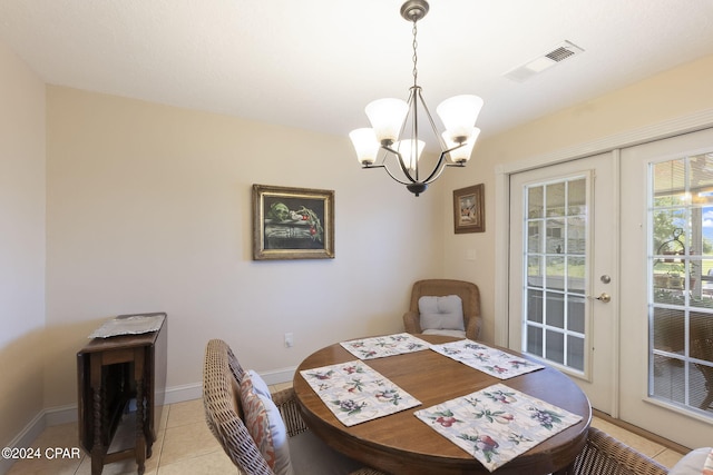 dining room featuring french doors, light tile patterned flooring, and a notable chandelier