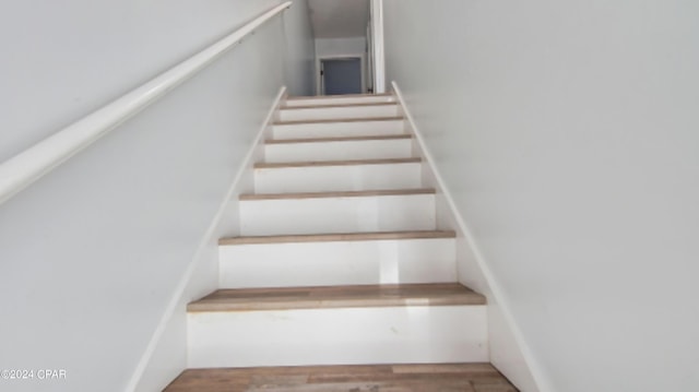 staircase featuring wood finished floors