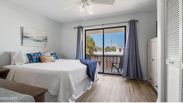 bedroom featuring access to outside, a ceiling fan, and wood finished floors