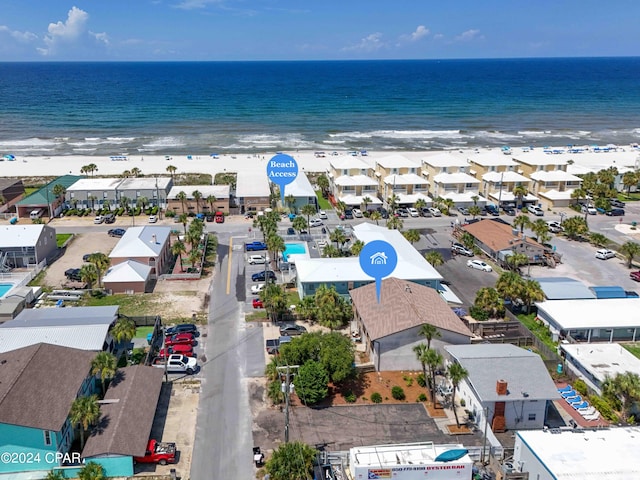 aerial view with a residential view, a water view, and a beach view