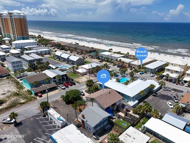 birds eye view of property with a water view and a view of the beach