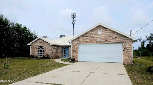 view of front of property with a front lawn and a garage