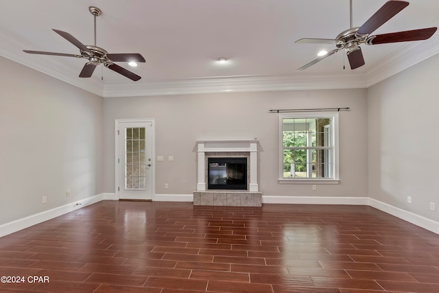 unfurnished living room featuring ceiling fan, a tiled fireplace, and ornamental molding