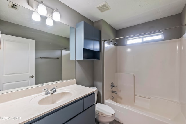 full bathroom with washtub / shower combination, a textured ceiling, toilet, and large vanity