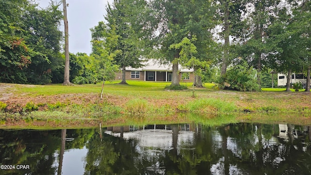 dock area with a water view and a lawn