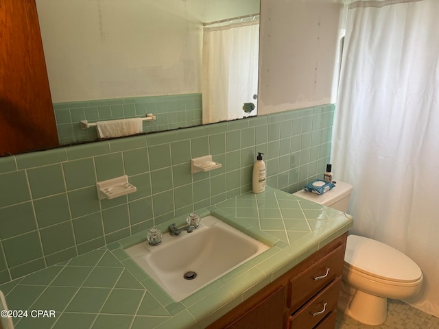 bathroom featuring tile walls, vanity, toilet, and tile patterned floors