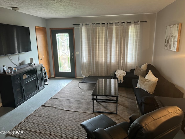 carpeted living room with a textured ceiling