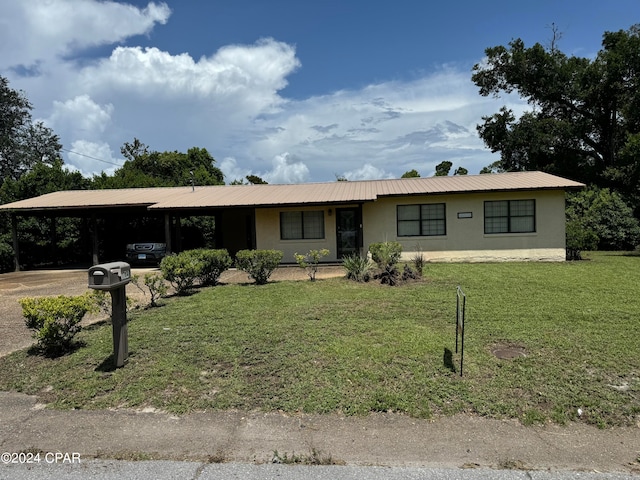 ranch-style house featuring a carport and a front yard