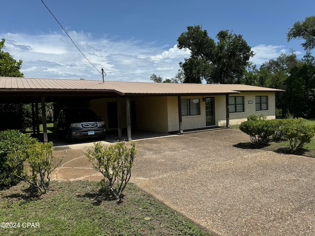 ranch-style home featuring a carport