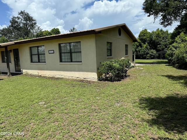 view of home's exterior with a yard