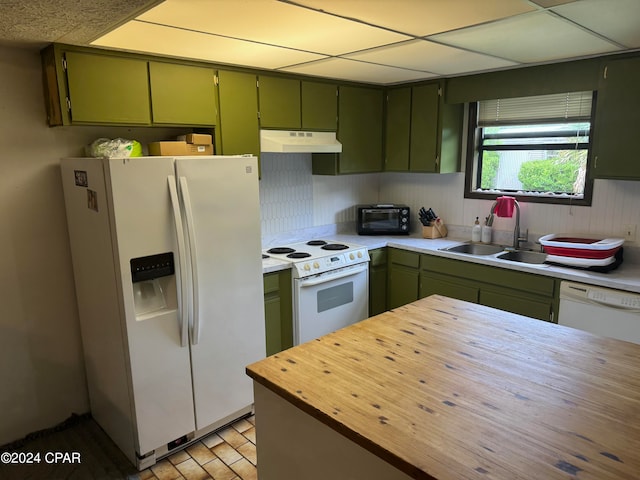 kitchen with white appliances and green cabinetry