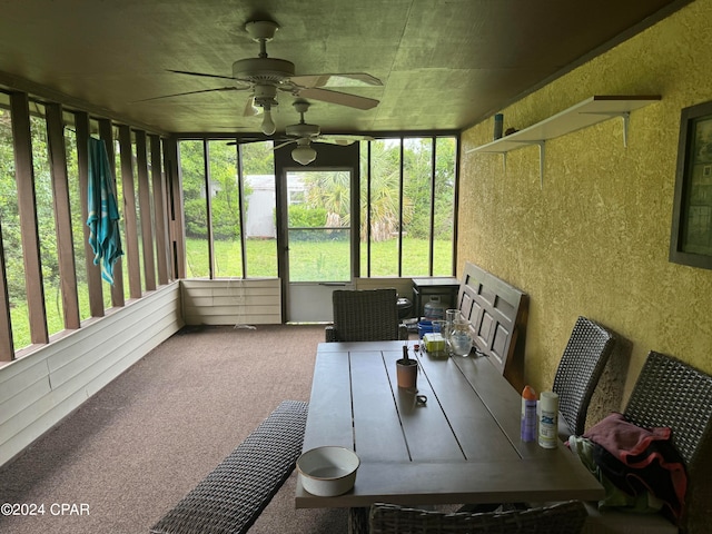 sunroom / solarium featuring ceiling fan