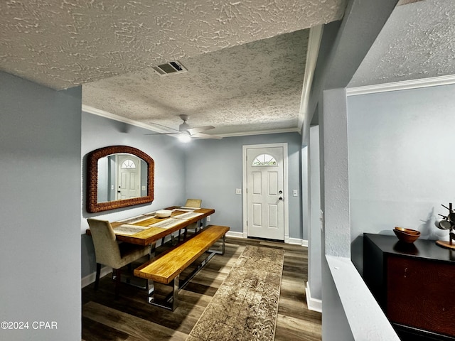 dining room with a textured ceiling, ceiling fan, wood finished floors, visible vents, and baseboards