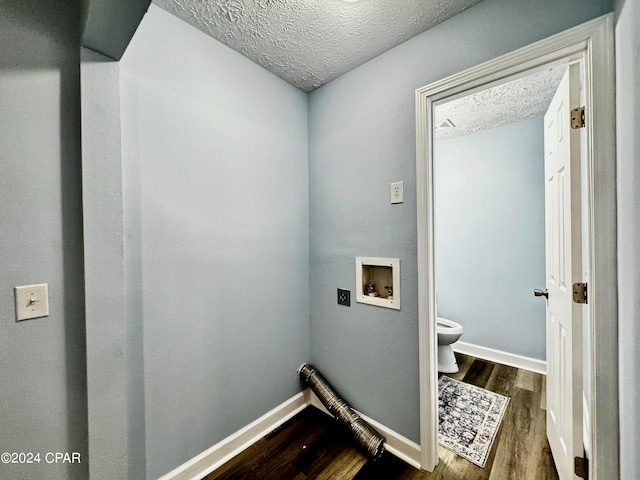 clothes washing area featuring laundry area, baseboards, dark wood-style floors, a textured ceiling, and washer hookup