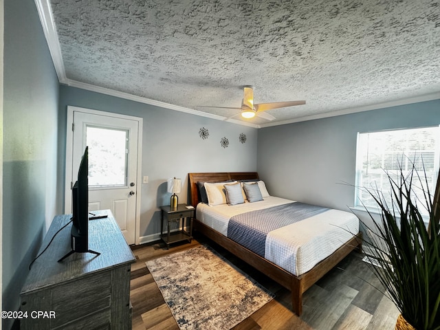 bedroom with ceiling fan, dark hardwood / wood-style flooring, ornamental molding, and a textured ceiling