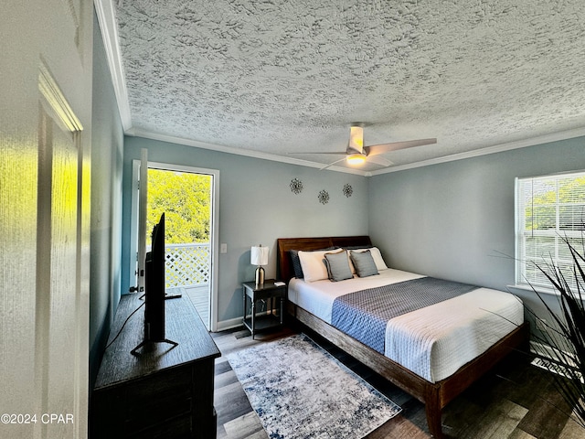 bedroom featuring multiple windows, a textured ceiling, ornamental molding, and hardwood / wood-style floors