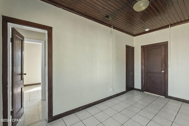 tiled spare room with wooden ceiling