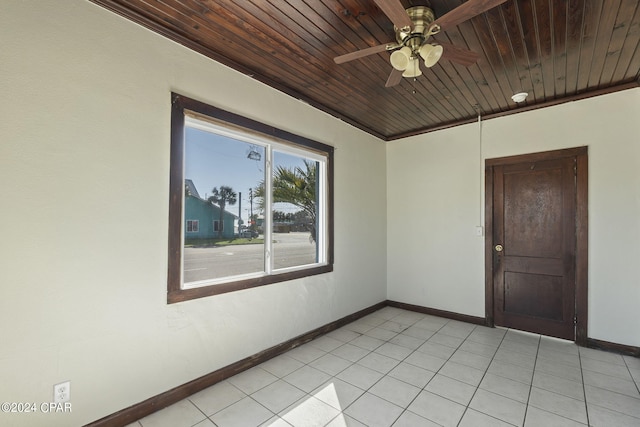 tiled spare room featuring ceiling fan, wood ceiling, and ornamental molding