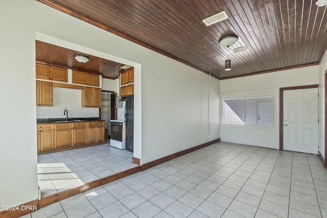 kitchen with crown molding, sink, light tile patterned floors, wooden ceiling, and white fridge