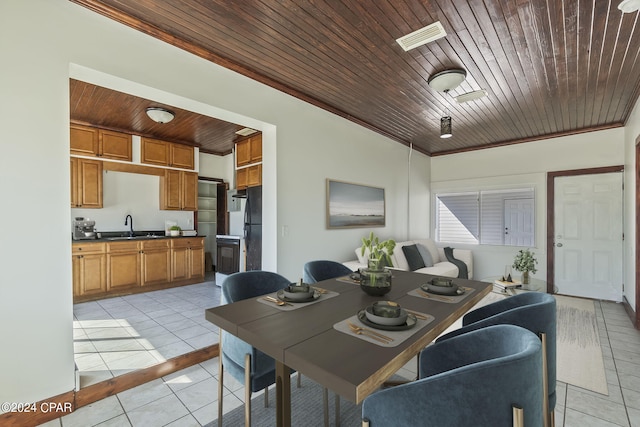 dining room with light tile patterned flooring, sink, crown molding, and wood ceiling