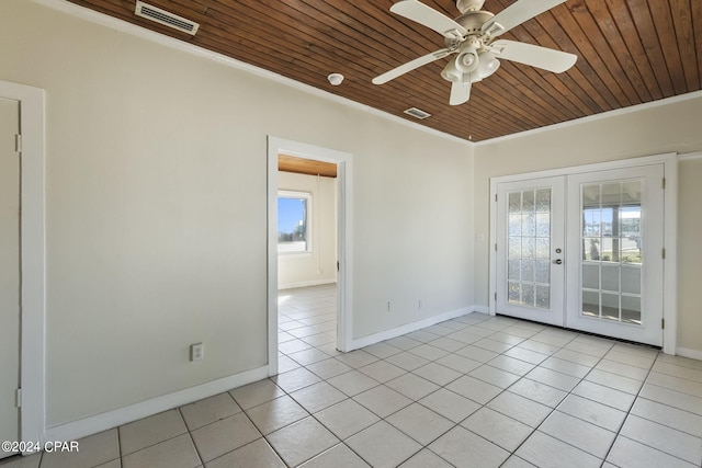 spare room with french doors, ornamental molding, ceiling fan, light tile patterned floors, and wooden ceiling