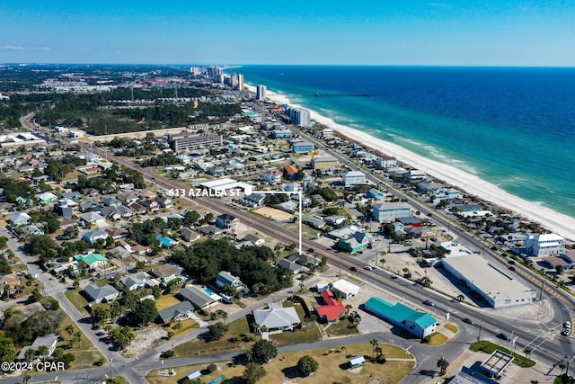 birds eye view of property with a water view and a view of the beach