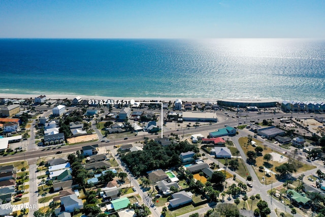 drone / aerial view with a water view and a beach view