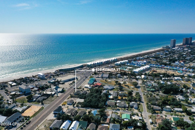 birds eye view of property with a water view and a view of the beach