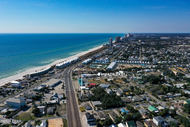 drone / aerial view with a water view and a beach view