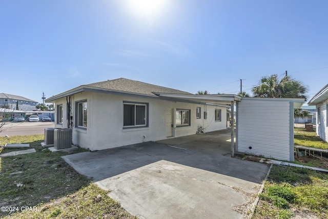 rear view of house featuring central air condition unit