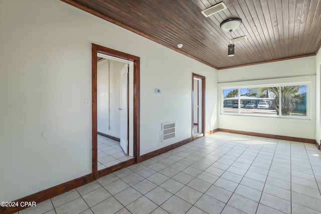 spare room featuring crown molding, light tile patterned floors, and wooden ceiling