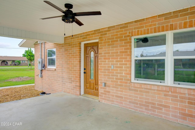 entrance to property with a patio area and ceiling fan