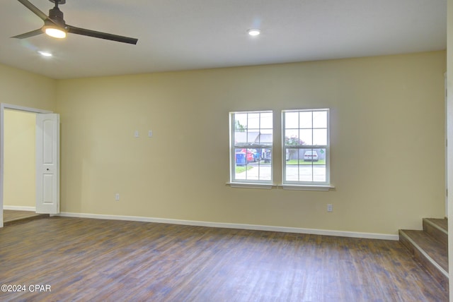 unfurnished room with dark hardwood / wood-style flooring and ceiling fan