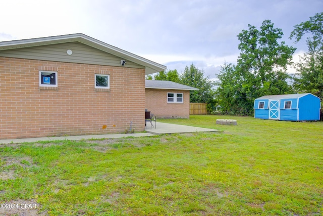 view of yard featuring a patio area and a storage shed