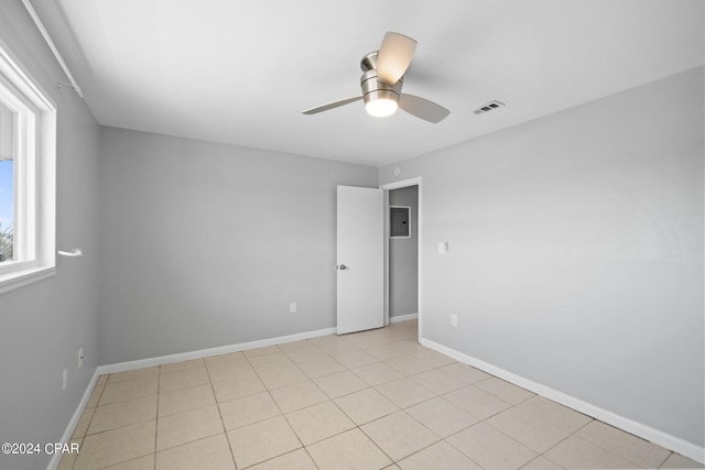 spare room featuring visible vents, ceiling fan, and baseboards