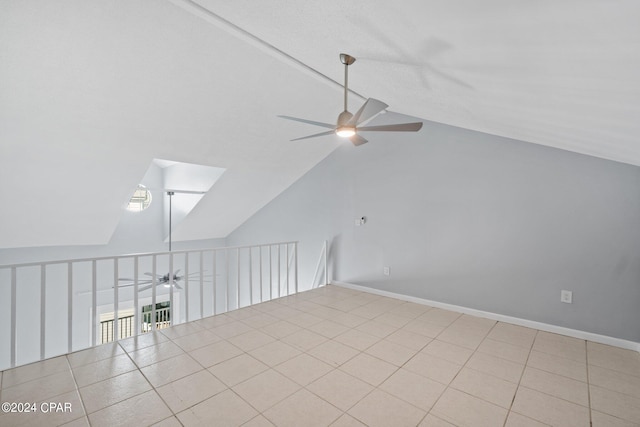 bonus room featuring vaulted ceiling, light tile patterned flooring, and ceiling fan