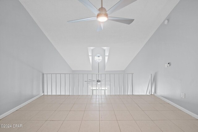 additional living space featuring ceiling fan and light tile patterned floors