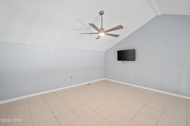 spare room with a ceiling fan, vaulted ceiling, and baseboards