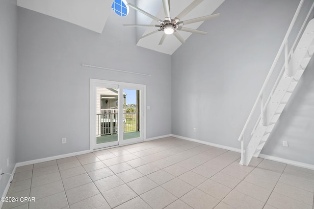 spare room featuring high vaulted ceiling, ceiling fan, baseboards, and light tile patterned floors