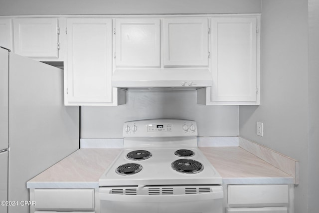 kitchen with light countertops, white appliances, white cabinets, and under cabinet range hood