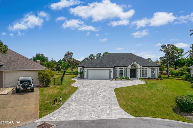 single story home with a garage and a front yard