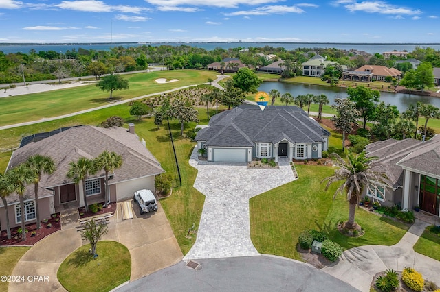 birds eye view of property with a water view and a residential view