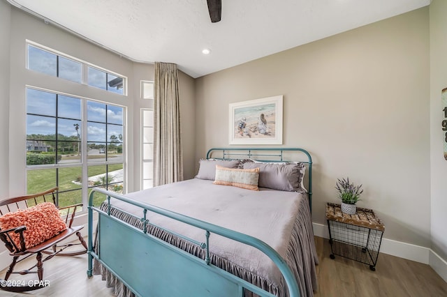 bedroom with ceiling fan, baseboards, wood finished floors, and recessed lighting