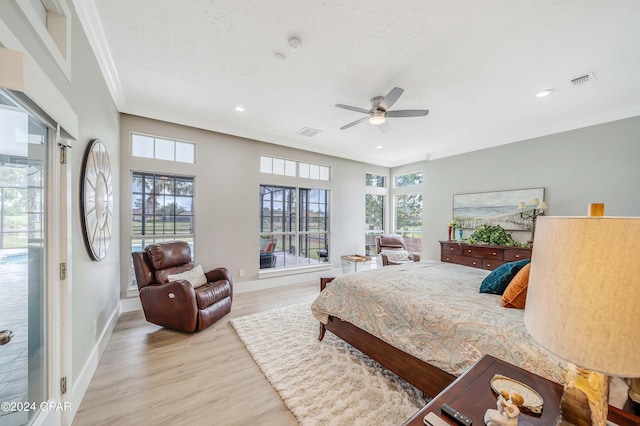 bedroom featuring light wood finished floors, baseboards, visible vents, and crown molding