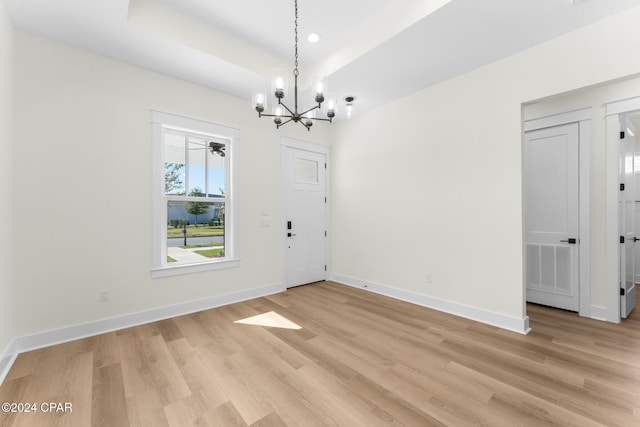 109 Johns Island Way, Panama City Beach, FL 32407 - unfurnished dining area with a chandelier, light wood-style floors, recessed lighting, and a tray ceiling