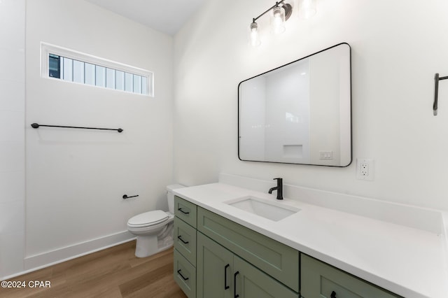 bathroom featuring hardwood / wood-style floors, vanity, and toilet