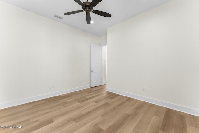 spare room with light wood-type flooring and ceiling fan