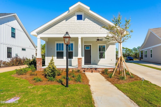109 Johns Island Way, Panama City Beach, FL 32407 - view of front facade featuring covered porch, a front yard, and a ceiling fan