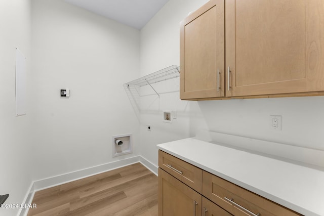 laundry room featuring hookup for an electric dryer, hookup for a washing machine, cabinets, and light wood-type flooring