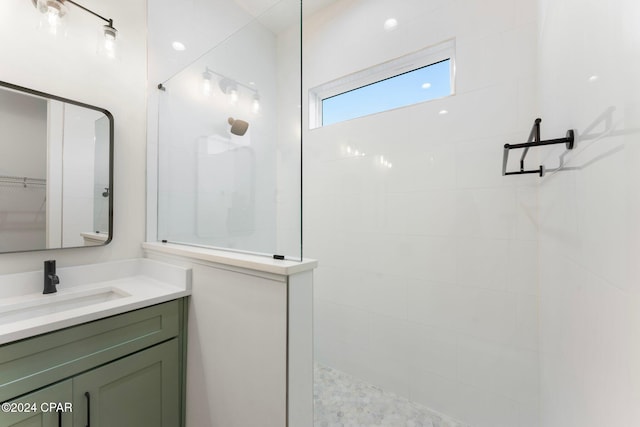 bathroom with vanity and tiled shower